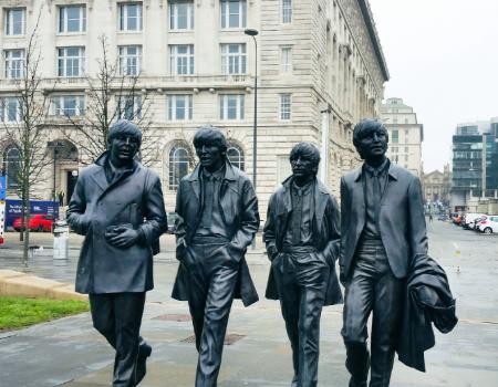 A statue of the Beatles in Liverpool, England on a classic tour